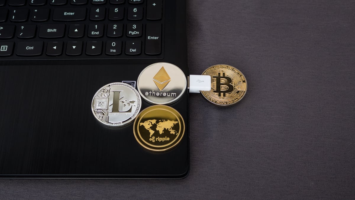 Cryptocurrency coins and a laptop